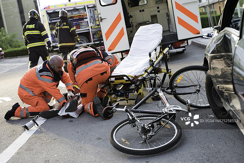 医护人员救助受伤的自行车骑行者图片素材