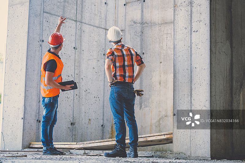 建筑工地上，工程师讨论结果图片素材