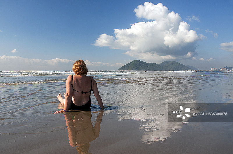 年长的女人背对着大海坐着图片素材