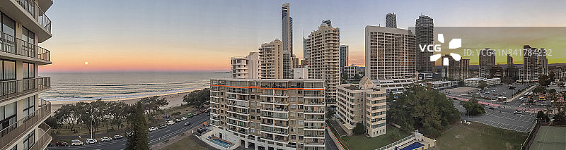 日落时分的冲浪者天堂天际线，满月从海上升起图片素材