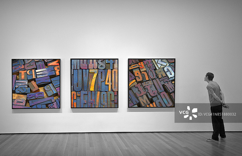 年轻男人看着相框里的照片图片素材