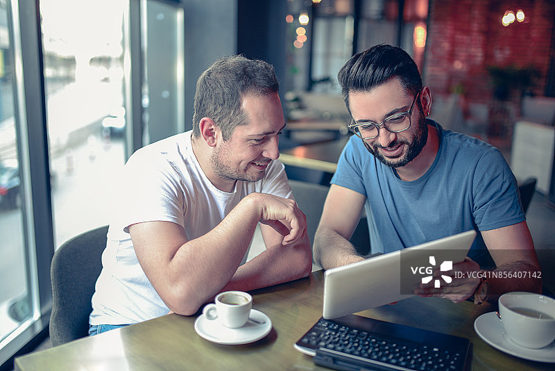 在咖啡馆餐厅喝咖啡工作的两位自由职业者图片素材