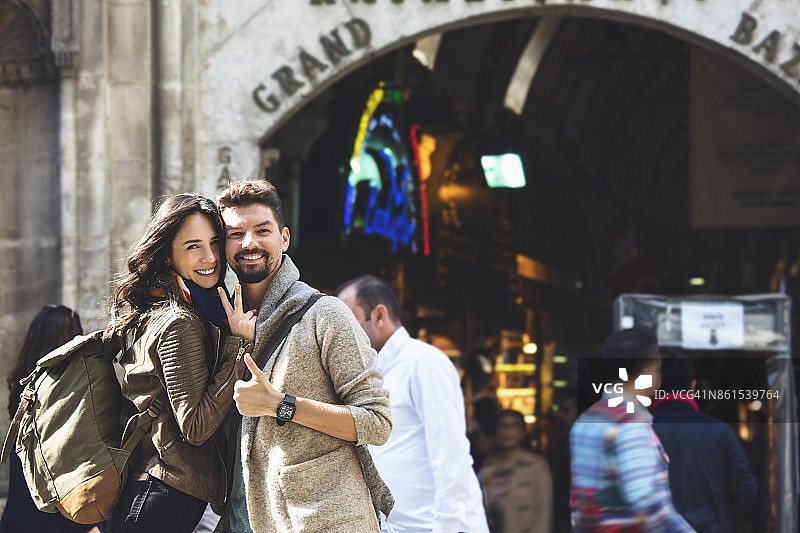 在土耳其伊斯坦布尔大巴扎入口附近的年轻游客情侣图片素材