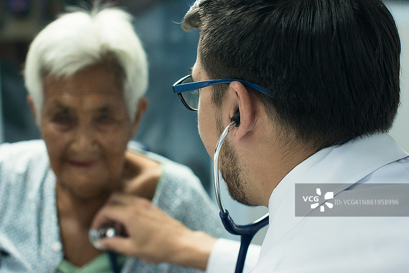 男医生听老年妇女的心跳和呼吸图片素材
