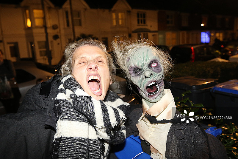 年长的金发女士模仿万圣节面具图片素材