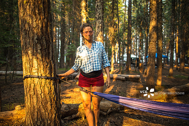 女人搭建露营吊床图片素材