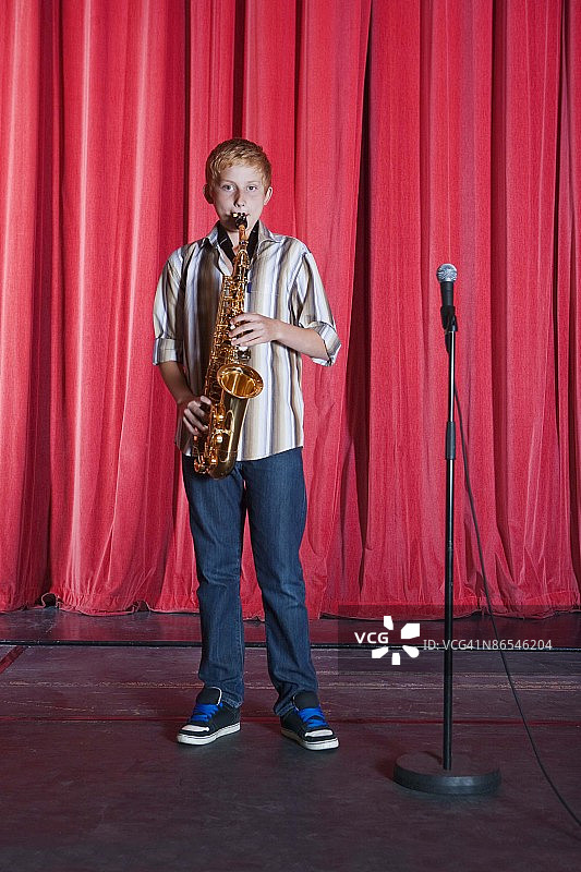 男孩在舞台上演奏萨克斯图片素材