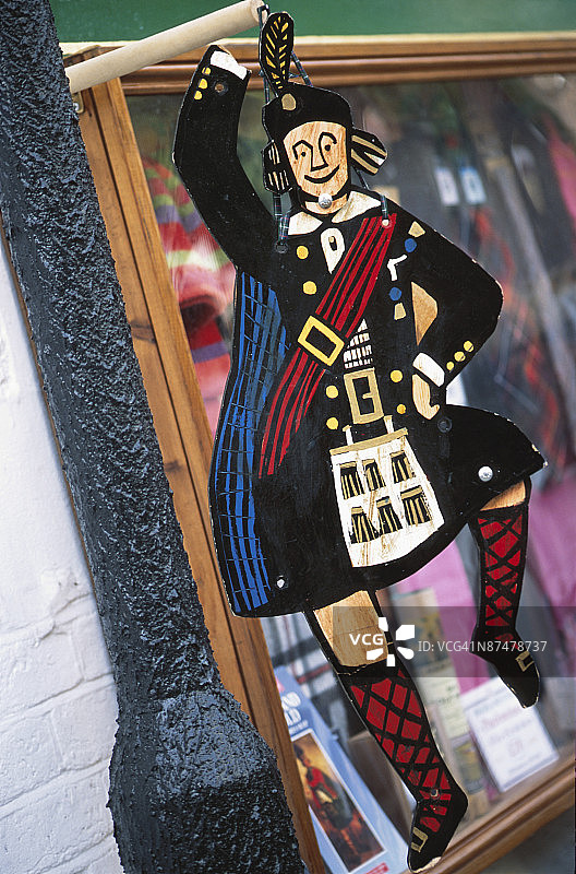 店铺外悬挂的苏格兰舞者人偶图片素材