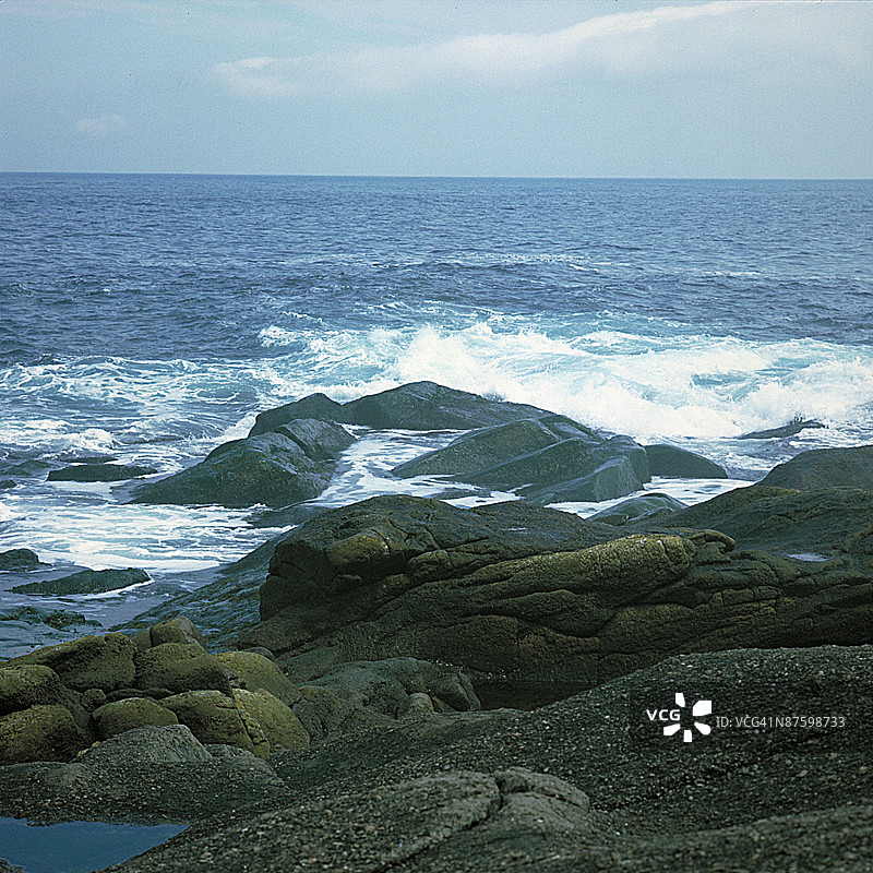 海浪在加拿大纽芬兰的斯皮尔角岩石海岸猛烈拍打图片素材