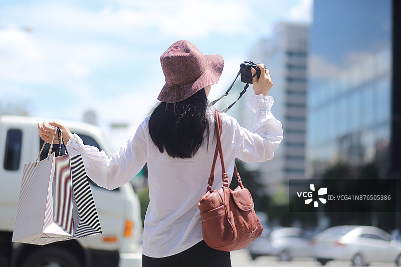 女游客在城市里拍照图片素材