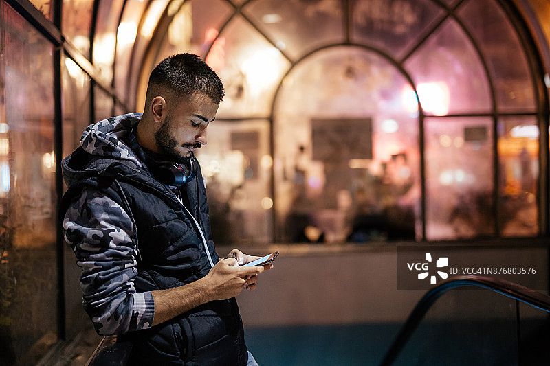 下班后在智能手机上打字的年轻男人图片素材