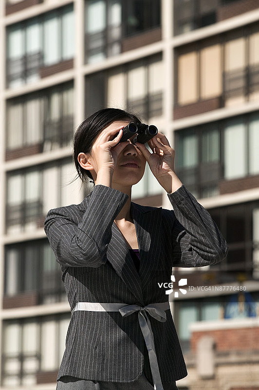 女人用双筒望远镜观看图片素材