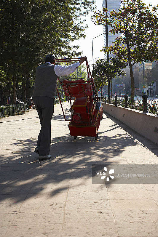 在墨西哥城人行道上推车的男人图片素材