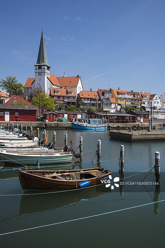 丹麦博恩霍尔姆岛伦讷港口的渔船和小艇与教堂图片素材