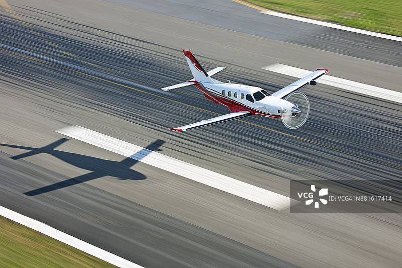 跑道上的飞机，带有阴影和运动模糊。图片素材