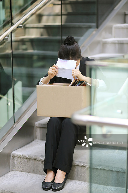 失业后拿着解雇通知的女商人图片素材