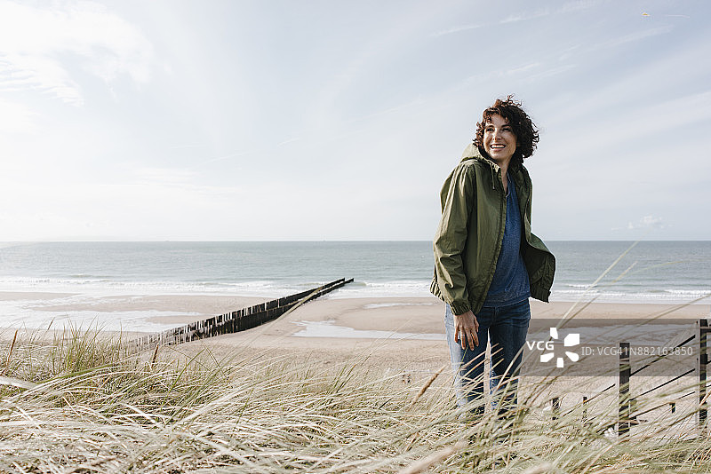 快乐的女人站在沙滩上图片素材