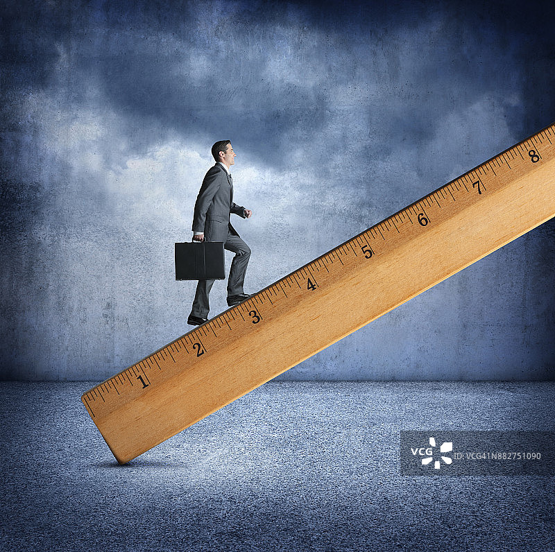 攀爬大木尺的商人图片素材