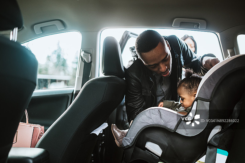 慈爱的父亲为女儿系安全带图片素材