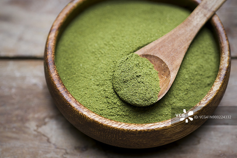 盛放有机辣木粉的木碗图片素材