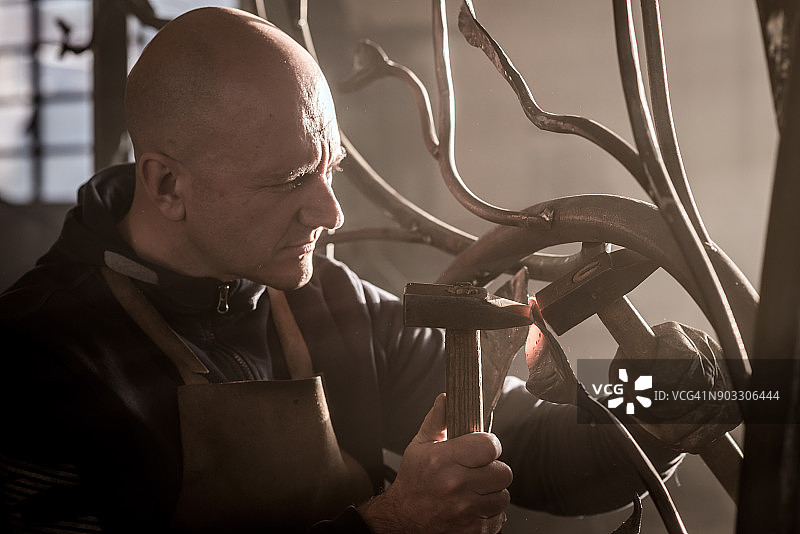 铁匠艺术家在他的铁匠工作室里制作门树图片素材