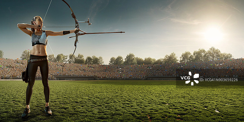 日落时分用长弓射箭的女性弓箭手图片素材