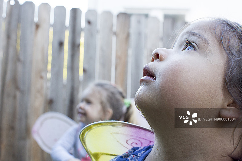 戴着仙女翅膀的好奇女孩在户外图片素材