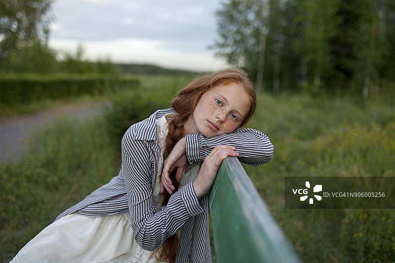 坐在长椅上沉思的白人女孩肖像图片素材