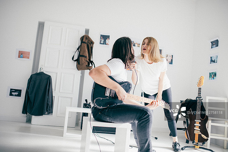 年轻情侣一起唱歌弹吉他图片素材