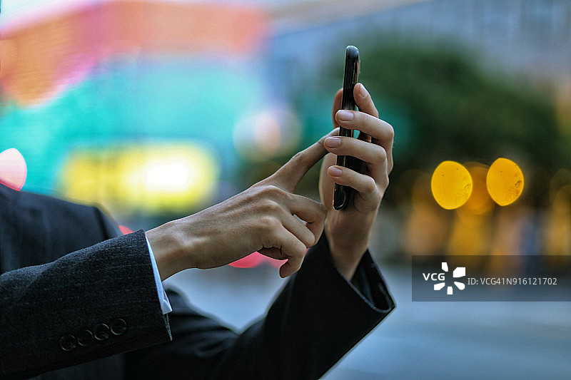 户外使用智能手机的商人特写图片素材