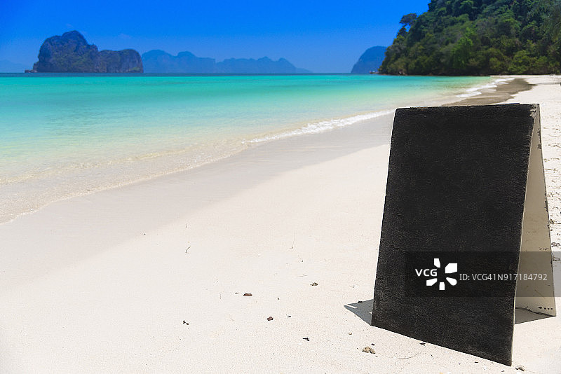 沙滩上空白的立式信息黑板，背景是美丽的海景，泰国董里府图片素材