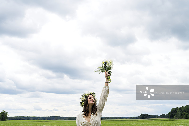 戴花环站在田野里的女人图片素材