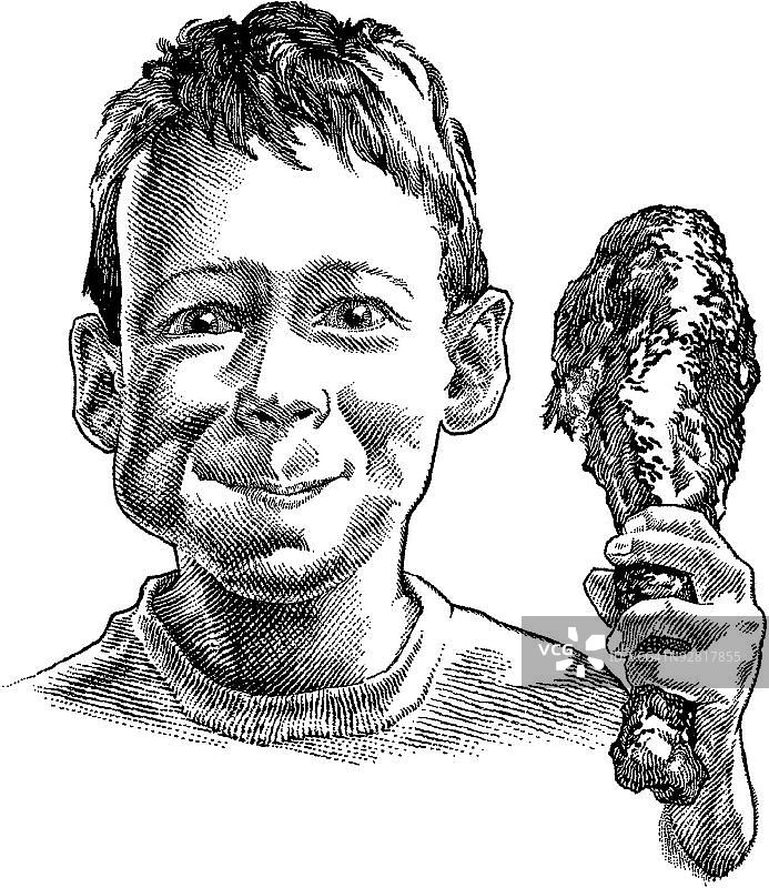 拿着鸡腿的男孩肖像图片素材