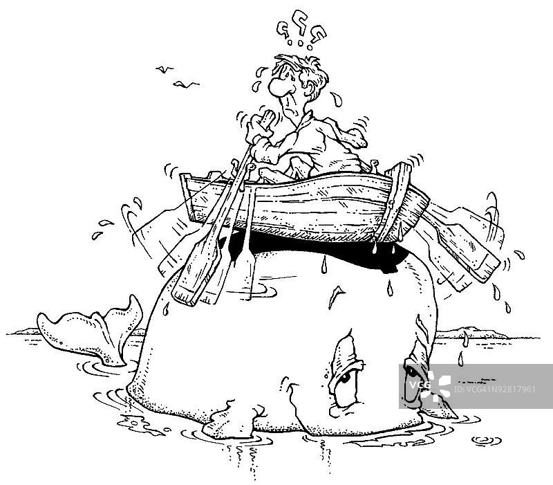 困在鲸鱼背上的船里的男人图片素材