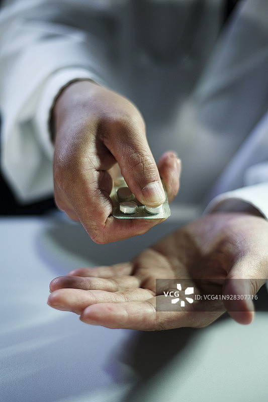 医生手持药物包装盒特写图片素材