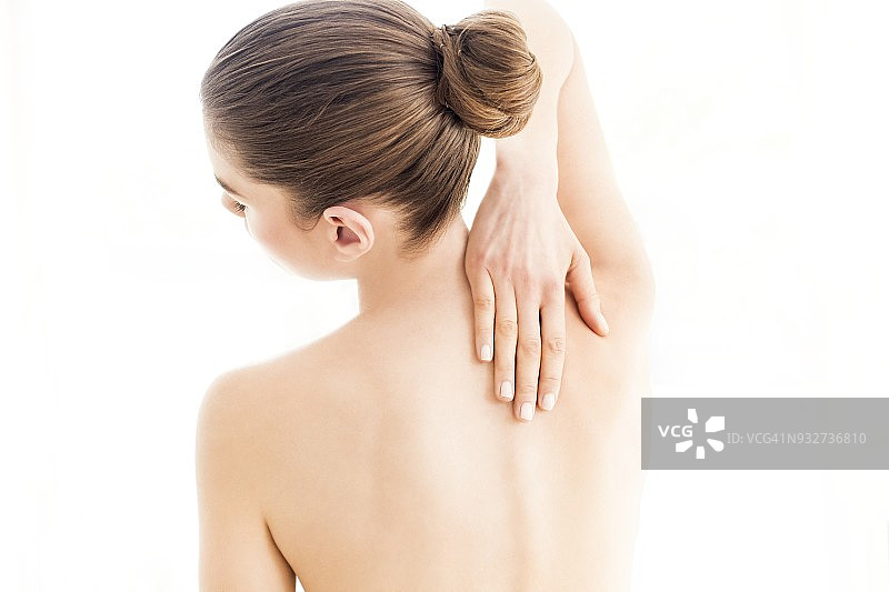女人触摸她的背部图片素材