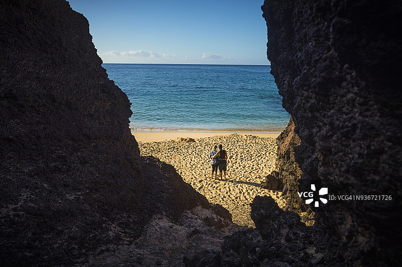 夫妇在毛伊岛大沙滩上享受阳光图片素材