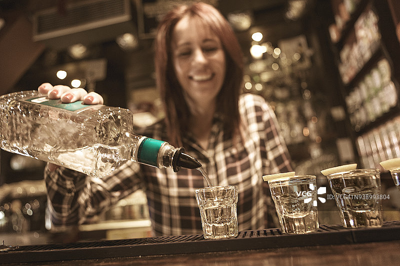 年轻女调酒师调制饮品图片素材