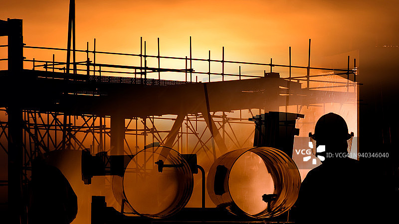 消防员用巨大的燃烧木材火焰扑灭大火的剪影图片素材