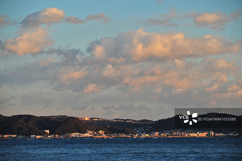 日本神奈川县叶山町叶山港和相模湾北太平洋上的橙色日落云彩图片素材