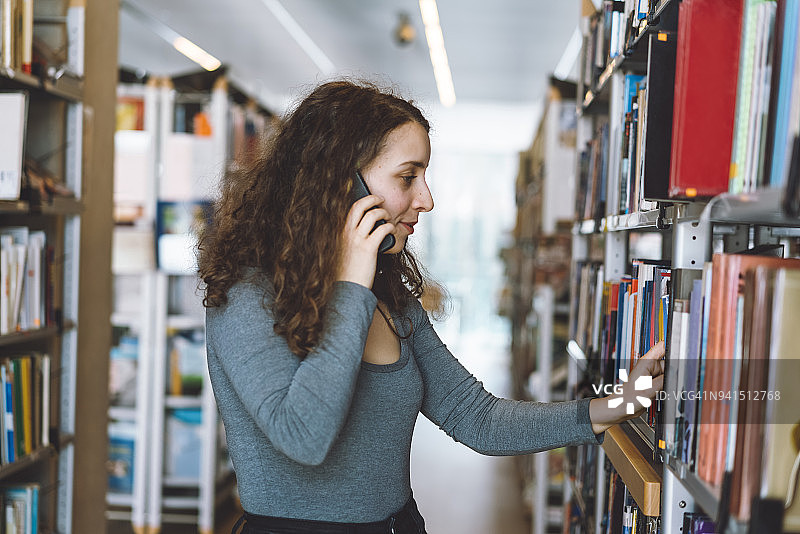 一边看书一边打电话图片素材