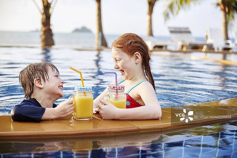 在游泳池里快乐的男孩和女孩图片素材