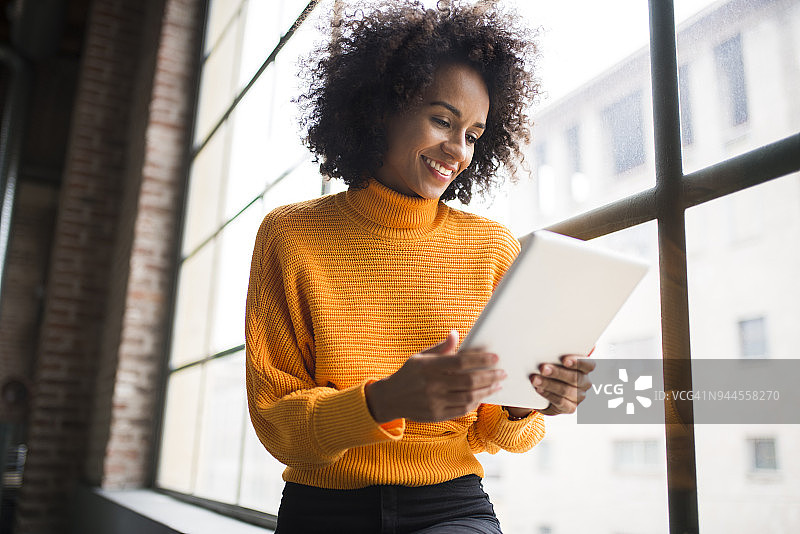 使用数位平板的微笑女人图片素材