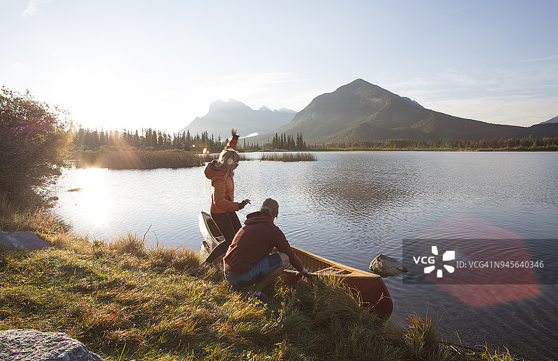 年轻男女在山区准备皮划艇，准备湖上泛舟图片素材
