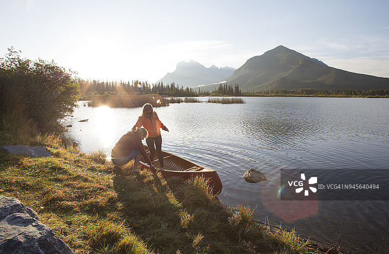 年轻男女在山区准备皮划艇，准备湖上泛舟图片素材