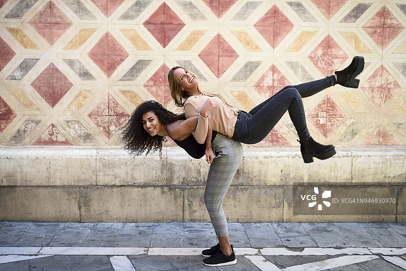 开心的女人背着她最好的朋友图片素材