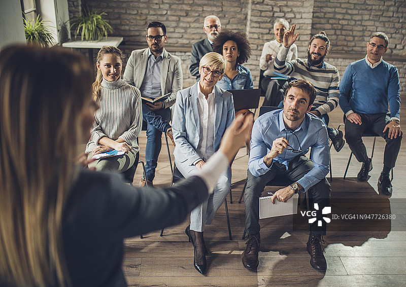 快乐的商人知道会议室研讨会上提出的问题的答案图片素材