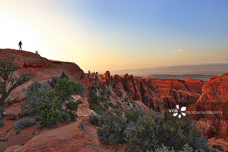 在拱门国家公园的岩石上徒步，双O拱门小径图片素材