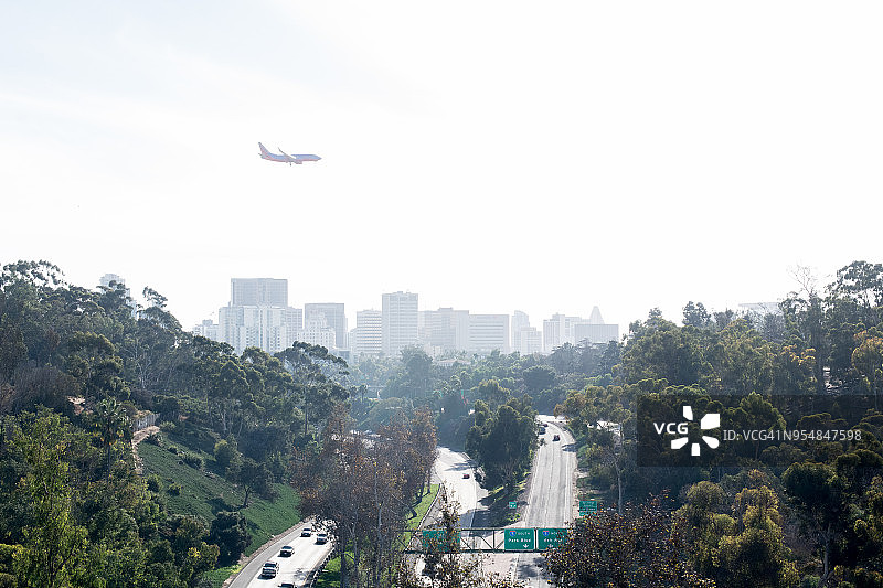 飞机、高速公路和城市天际线图片素材