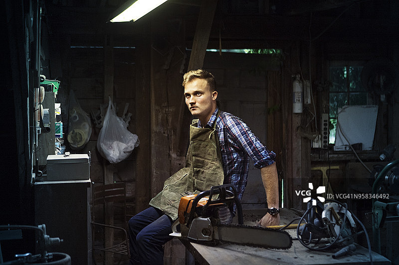 木匠坐在工作室内桌旁图片素材